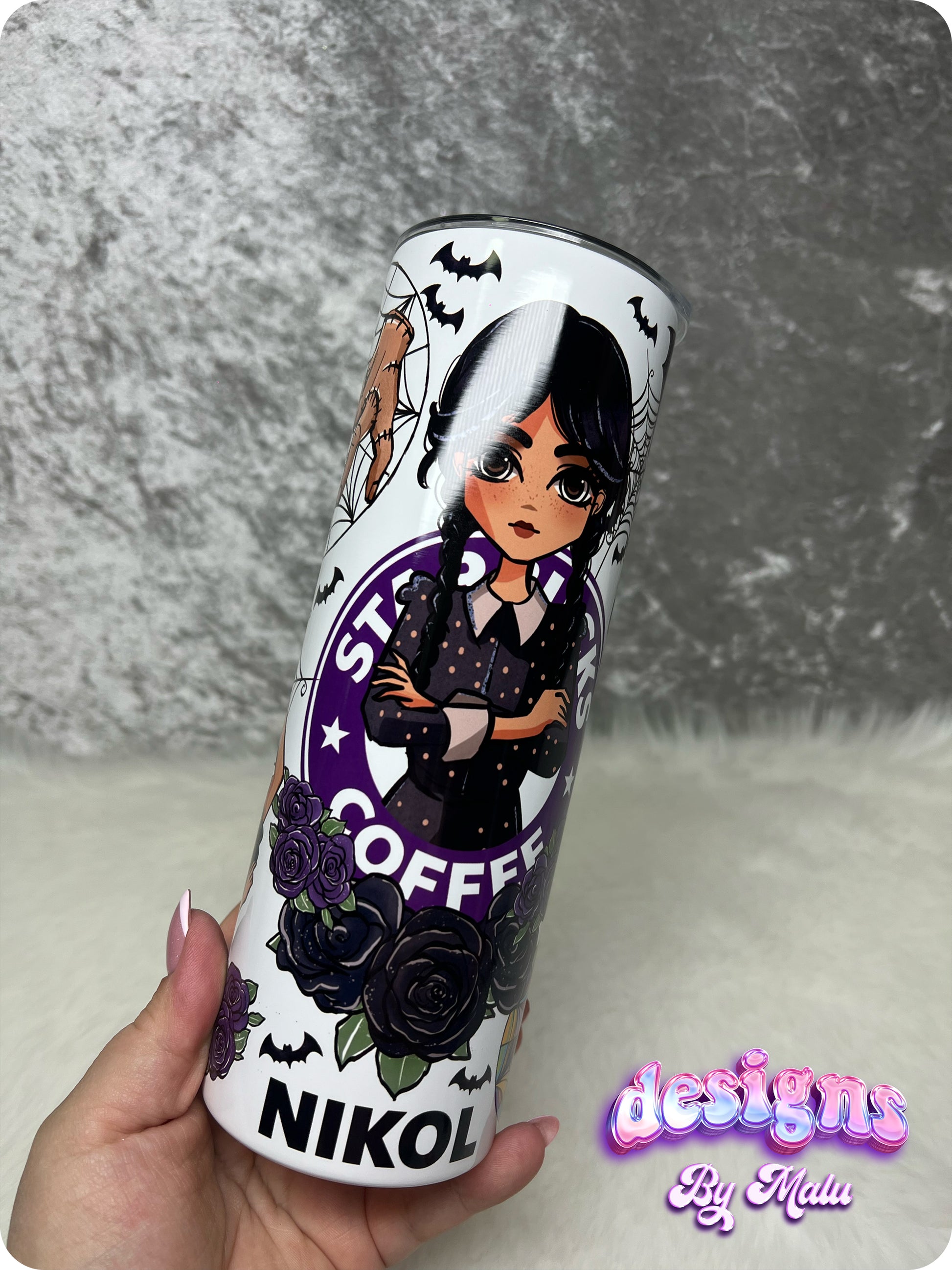 Personalised Wednesday Addams Starbucks Coffee Tumbler, featuring a gothic-style cartoon character with black braids, surrounded by purple roses and bats. This 20oz straight tumbler is beautifully designed with a ‘starbucks Coffee’ inspired logo and can be customised with any name. Perfect as a gift for her, this tumbler comes complete with a lid and straw, making it both stylish and functional for everyday use.